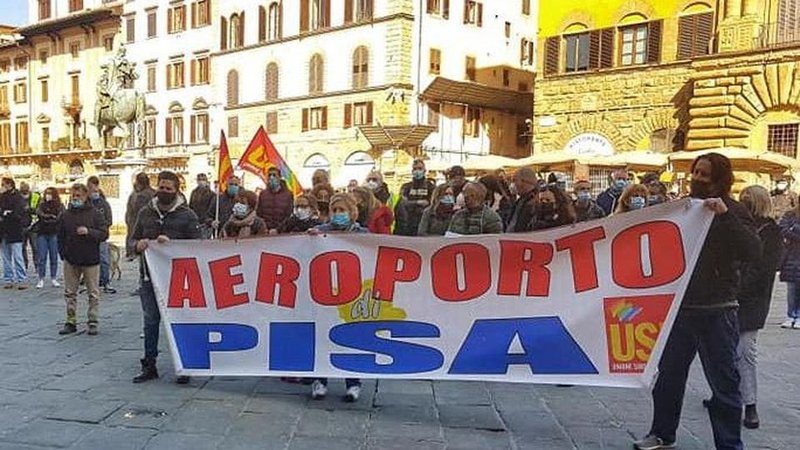 Pisa airport workers under flags and banners of a local union, protest against the use of their labor to fuel war.