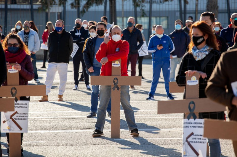  At the height of the third wave massacre, hoteliers in Lorca, Murcia, protest carrying crosses as a sign of mourning... for their businesses.