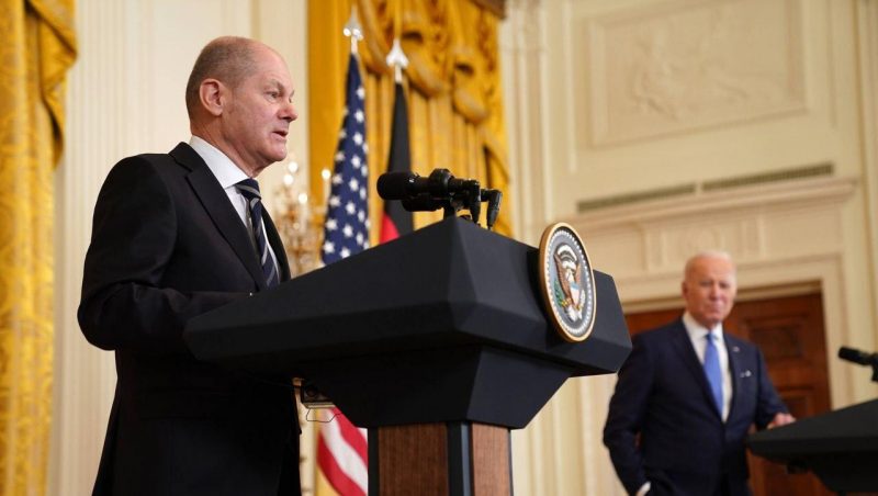 Biden looks grimly at Scholz during the joint press conference after their meeting at the White House